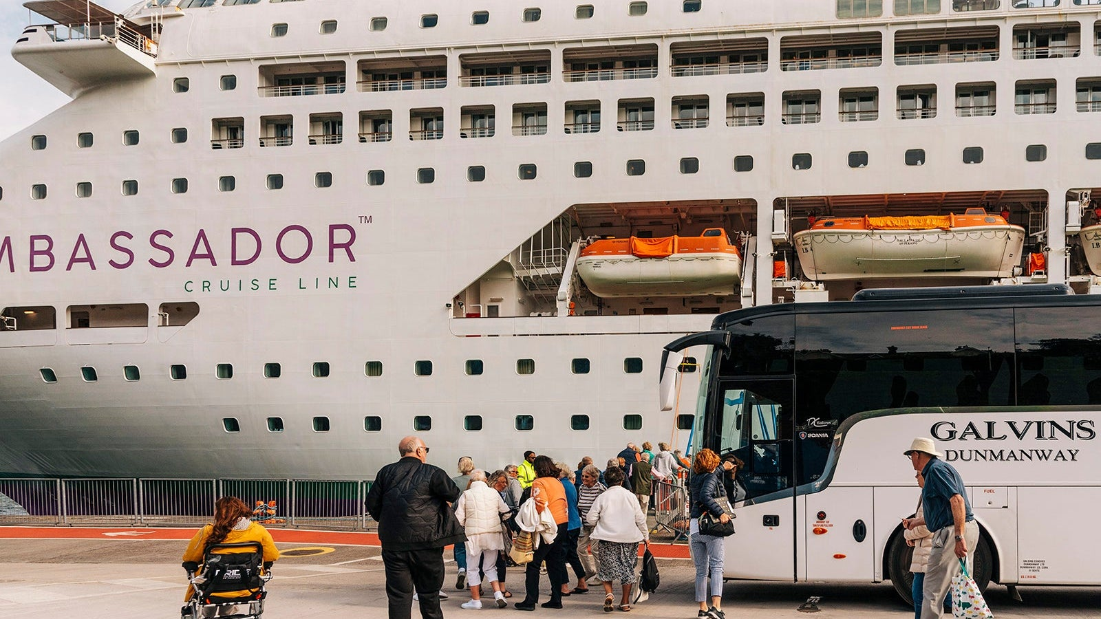 Cruise-passengers-exiting-a-excursion-coach-and-return-to-their-cruise-ship-alongside-in-Cobh-Harbor-Ireland_Peter-TitmussUCGUniversal-Images-Group-via-Getty-Images